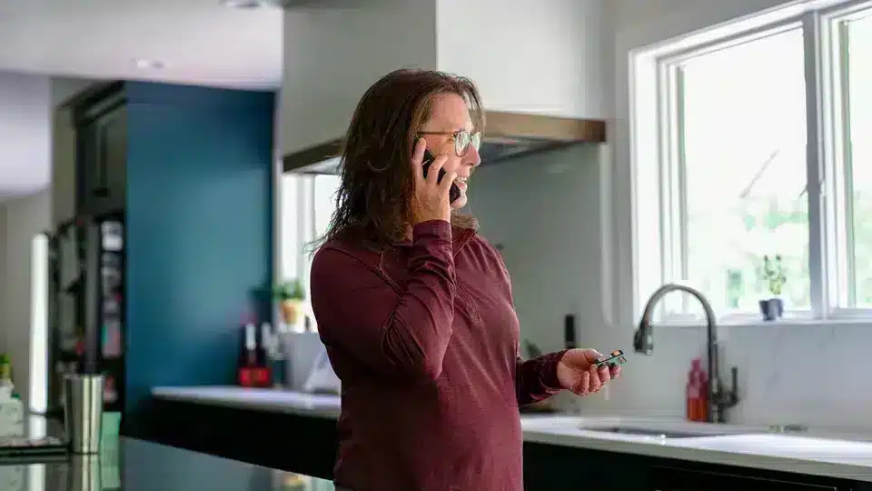Customer on her phone in residential kitchen in Lockport.