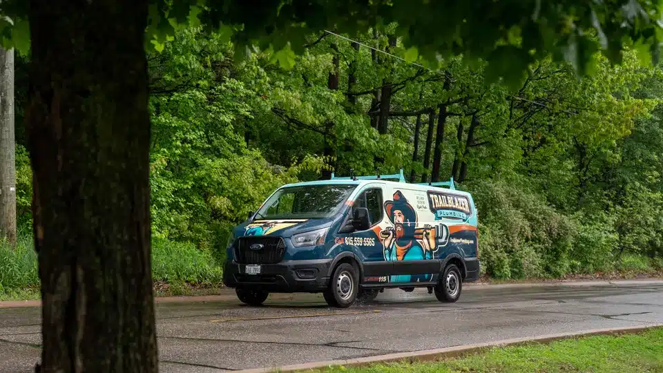 Trailblazer Plumbing truck driving down road in Lockport.