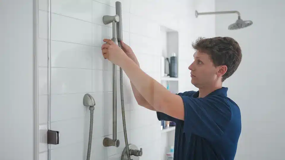 Trailblazer tech adjusting shower fixture in residential bathroom in Lockport.