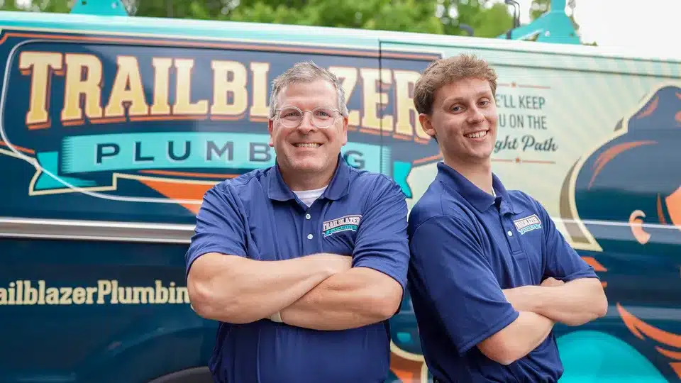 Trailblazer Plumbing techs smiling with crossed arms in Lockport.