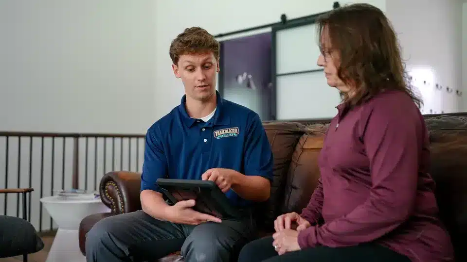 Trailblazer tech talking to customer in residential home in Lockport.