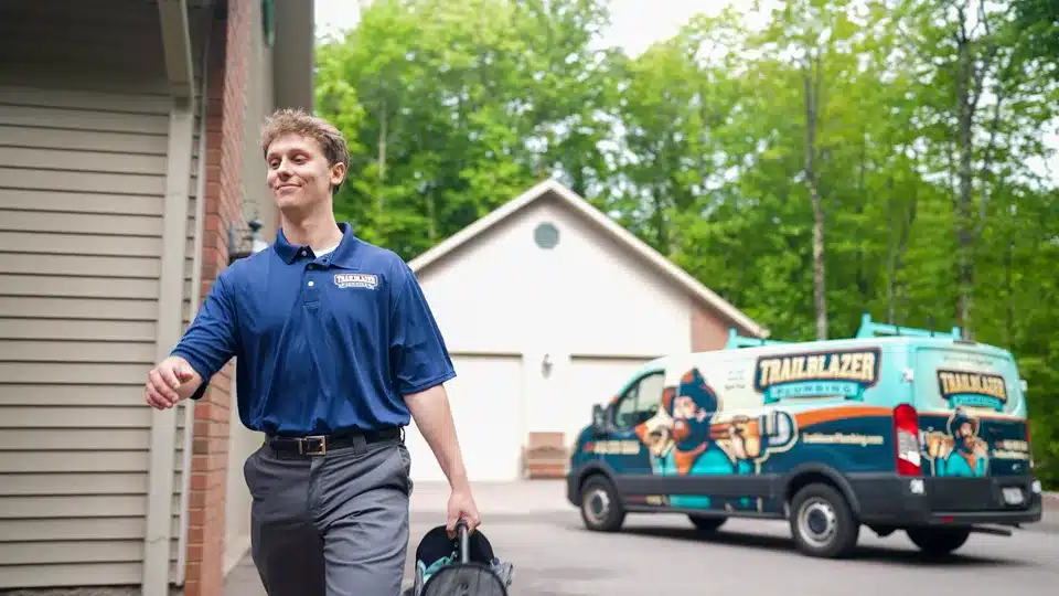 Trailblazer Plumbing tech walking to customers home in Lockport.