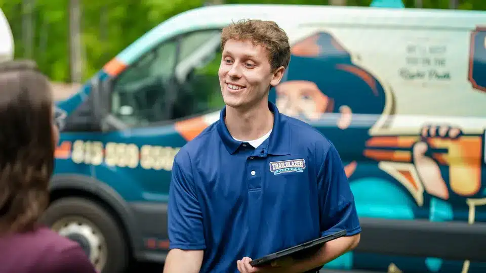 Trailblazer tech smiling and shaking hands with customer in Lockport.
