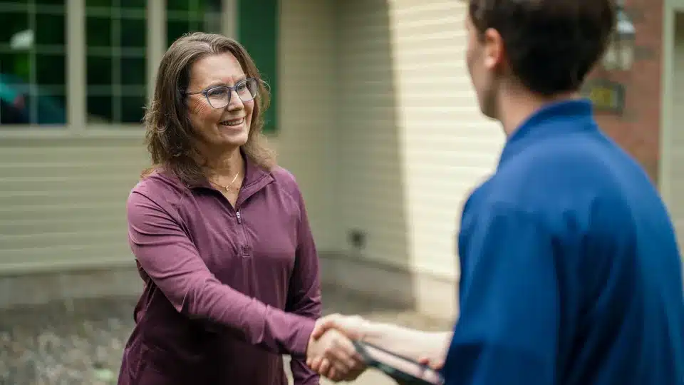Trailblazer tech shaking hands with customer in Lockport.
