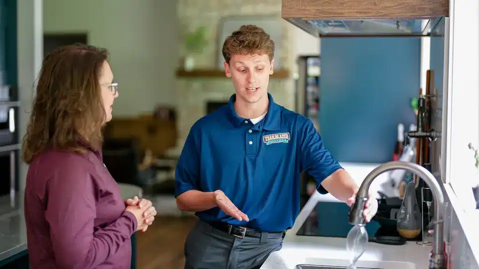 Trailblazer Plumbing tech helping customer in kitchen in Lockport.