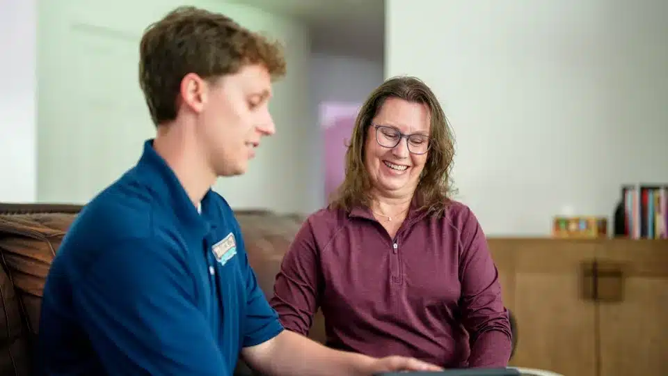 Trailblazer tech talking to customer in residential home in Lockport.