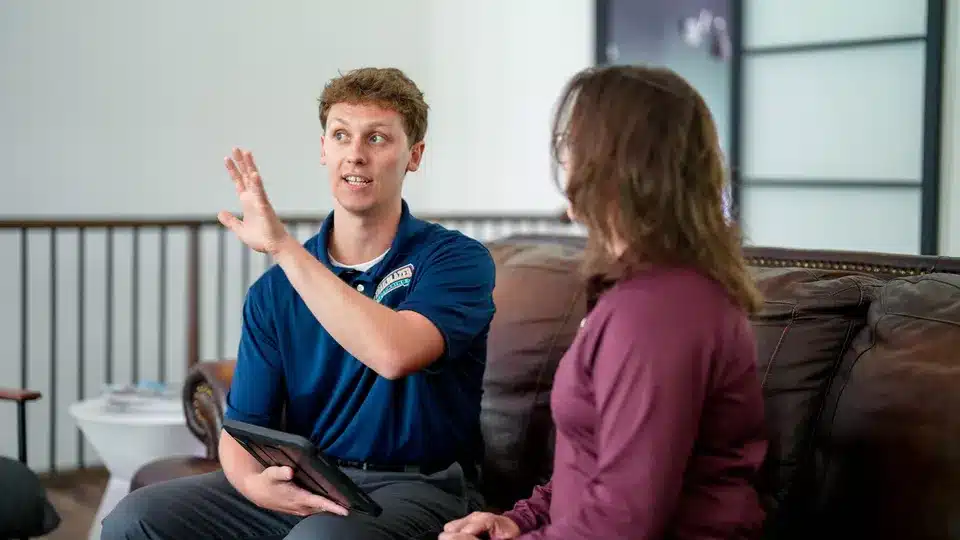 Trailblazer tech talking to customer in residential home in Lockport.