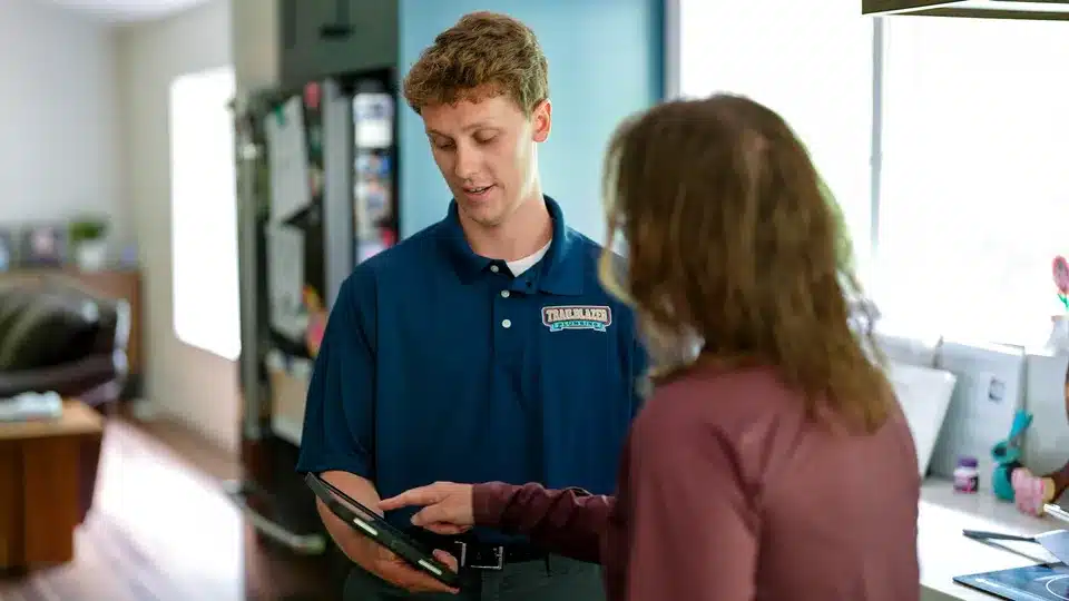 Trailblazer tech talking to customer in residential home in Lockport.